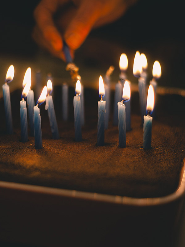 Close up of burning candles on a cake