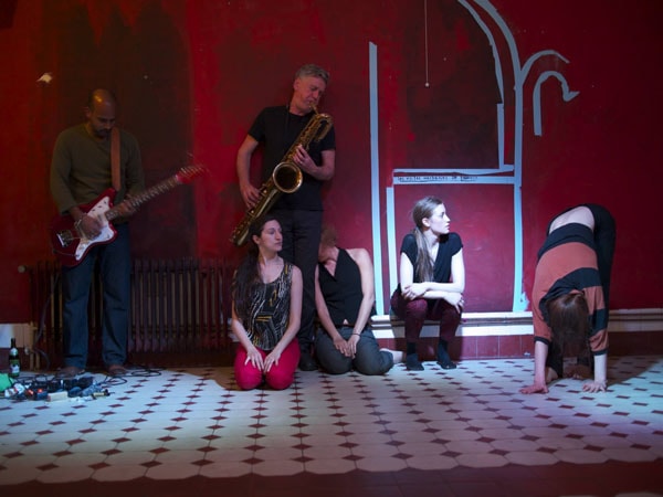 Photo of musicians and dancers on tiled floor